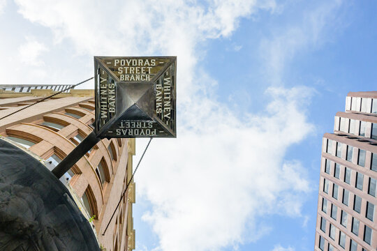 New Orleans, LA, USA - September 9, 2026: Underside of the Clock at the Historic Poydras Street Branch of the Whitney Bank in the Central Business District and another Downtown Building Looking Up