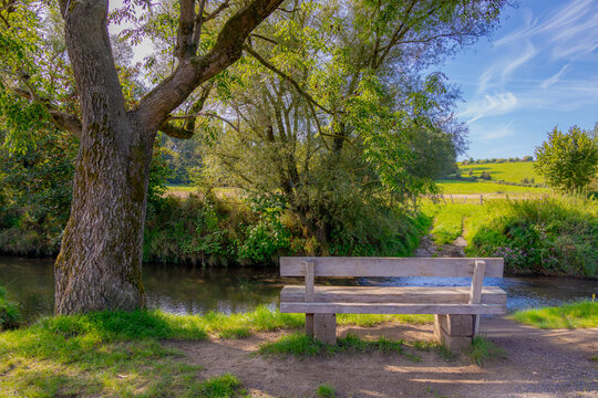 Autumn landscape, Terrain hilly countryside in Zuid-Limburg with wooden bench along small river kleine Geul and trees, Epen is a village in southern part of the Dutch province of Limburg, Netherlands.