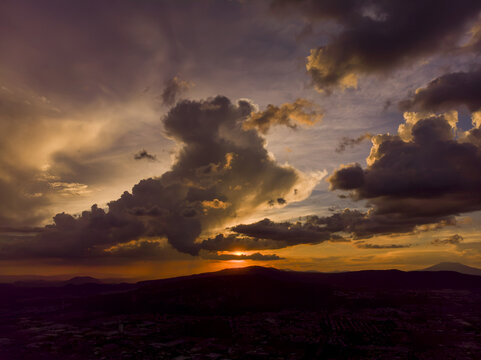 Aerial view of a dramatic sunset over the landscape and urban area of Tlaquepaque, Jalisco, Mexico.
