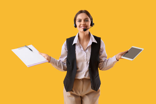 Customer support and service excellence, smiling call center agent holding clipboard and tablet for digital communication on a yellow background