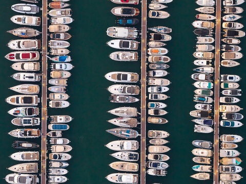 Aerial view of numerous yachts and motorboats docked in neat rows at the marina in Antibes, Provence-Alpes-Cote d'Azur, France.