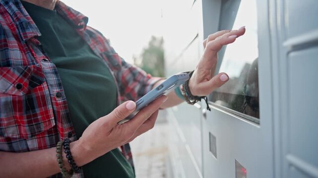 Girl Entering A Pickup Code On Self-Service Parcel Locker Screen To Pick Up Package At Street