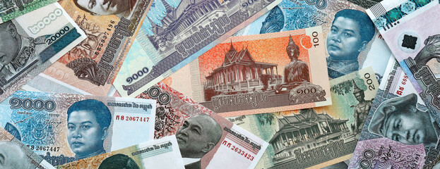 Cambodian riel money banknotes pile on table. Cambodia bills of KHR currency close up © Larysa