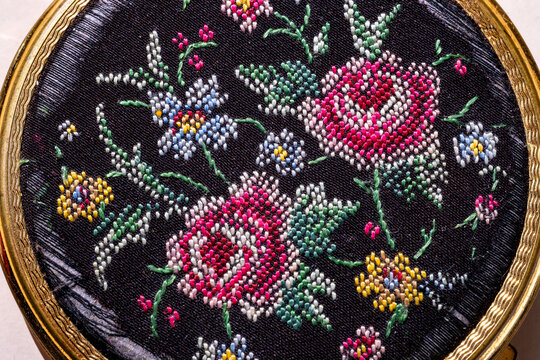 Vintage Austrian powder compact, petit point embroidered floral motif on black silk, ornate gold frame, 19th-century luxury toiletry accessory, cultural heritage Habsburg-era, European aristocracy