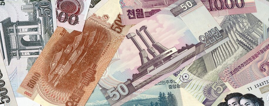 North Korean won money banknotes bunch on table. North Korea bills of KPW currency