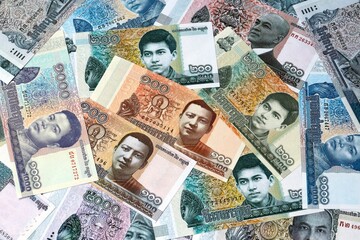 Cambodian riel money banknotes bunch on table. Cambodia bills of KHR currency close up © Larysa