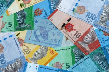 Malaysian ringgit money banknotes pile on table. Malaysia bills of MYR currency close up © Larysa