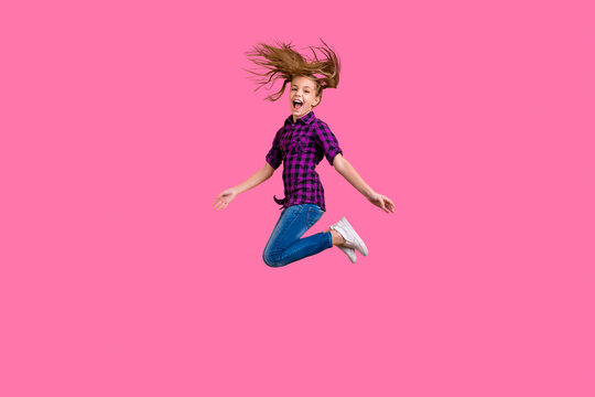Full size side photo of small pupil jump high hooray holidays wear casual checkered shirt jeans denim isolated yellow background