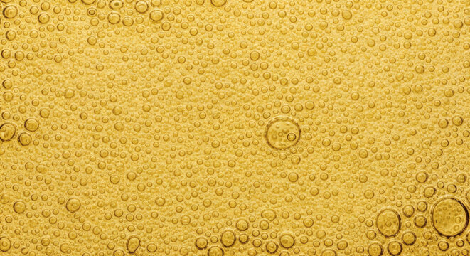 Golden beer bubbles texture background showing carbonated liquid surface with many small circular air spheres for beverage advertising design
