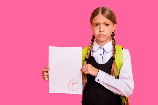 Portrait of her she nice attractive lovely disappointed unlucky pre-teen blonde girl showing bad fiasco mark score first grade isolated on bright vivid shine orange background