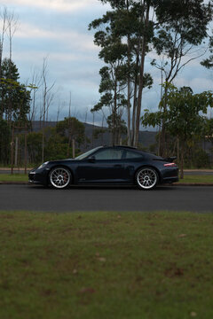Dark Blue Porsche 911 Carrera GTS Sports Car Side Profile View Parked Outdoors
