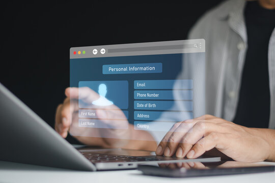 Businessman entering personal information on online registration form via laptop and smartphone. data protection, privacy lock, hidden data, consent form, secure database, private cloud technology.