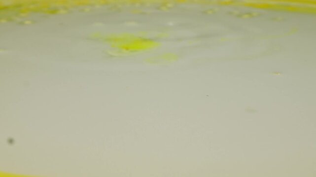 Window glass with yellow soapy water and bubbles, washing office window with cleaning solution, commercial cleaning service close up macro