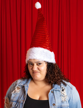 Woman in Santa hat making a funny humorous displeased face