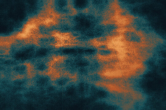 Vibrant abstract nebula with glowing orange clouds and deep teal background for space exploration themes and science fiction.
