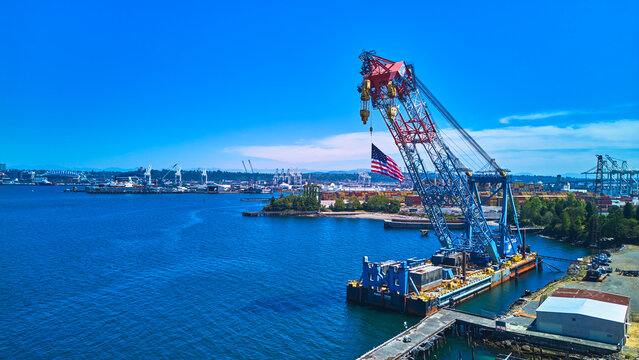 Aerial Industrial Crane with American Flag at Seattle Port Waterfront