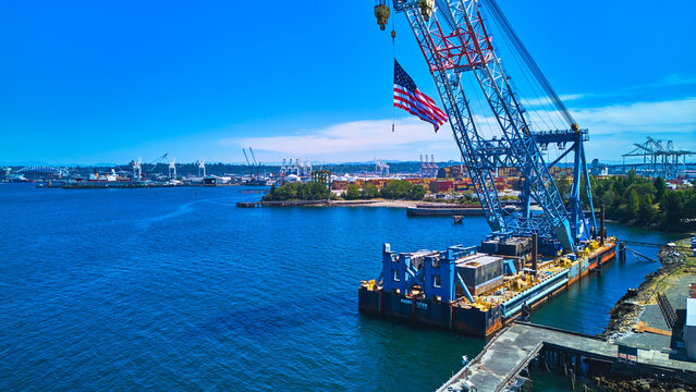 Aerial American Flag Crane and Waterfront Industrial Scene Seattle