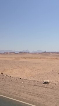 Expansive desert landscape with distant mountain ranges under a clear blue sky Egypt. Hurghada