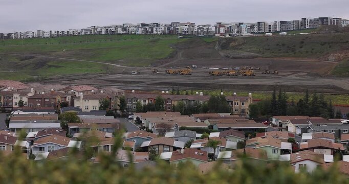 Excavators level a hillside in the Communications Hill neighborhood to build more housing and development in San Jose, California, USA.