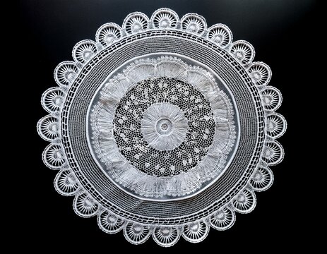 white lace paper doily with decorative scalloped edges and floral patterns