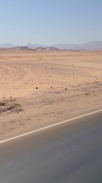 Vast desert highway with distant mountains under clear blue sky Egypt. Hurghada