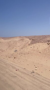 Vast desert landscape under clear blue sky with sandy terrain and rugged hills Egypt. Hurghada