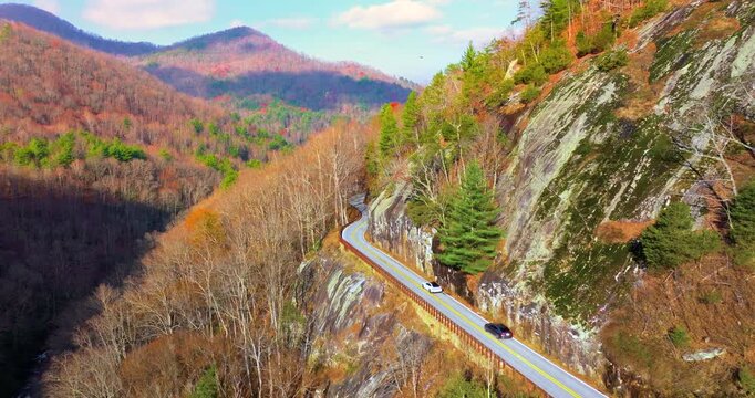 Car travels along scenic Highlands Road. Golden foliage and rugged slopes make this North Carolina highway a perfect fall escape.