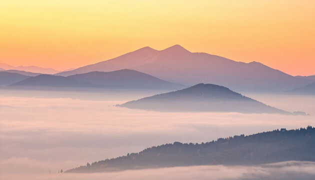 Mountain landscape, misty valley, and layered ridge at sunrise create tranquil scenic panorama with soft pastel light and atmospheric fog