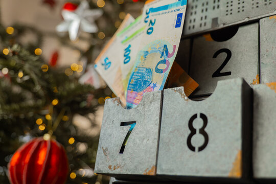 December gifts. seasonal expenses.decorative calendar drawers near a glowing Christmas tree. for holiday savings, preparing an annual Christmas fund, financing expensive gifts