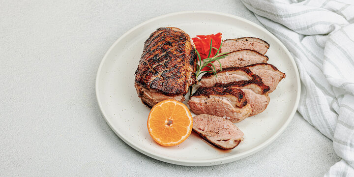 Fried duck breast with fresh orange and ginger, ready to eat food. Domestic cuisine, poultry meat