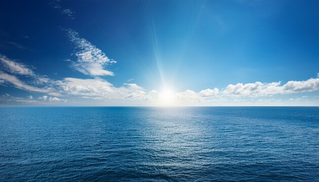 vast ocean blue sky and sun