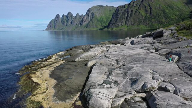 Aerial view, rocky coastline with dramatic mountains in the background, tide pools, rocky coast of Tungeneset, Devil's Teeth rock peak, Devil's Teeth, Okshornan, Steinfjorden, Senja island, Troms, No