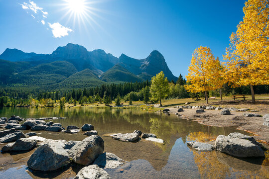 Quarry Lake autumn landscape with yellow leaves reflecting on clear water. Canmore, Alberta, Canada.