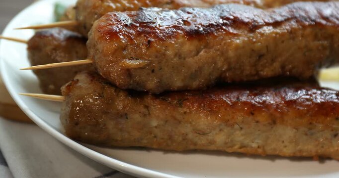 Tasty kebabs with spices on table, closeup