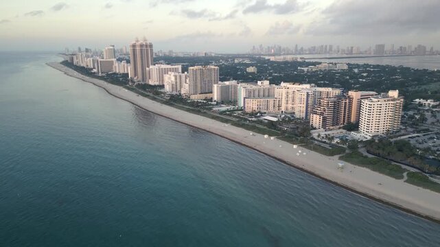Aerial sweep along miami beach coastline at dawn