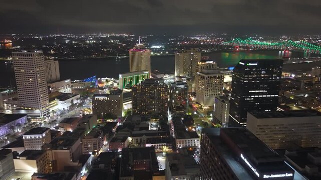 High-angle view of downtown New Orleans illuminated at night with modern skyscrapers and commercial buildings. Vibrant Louisiana skyline showcases contemporary urban architecture.