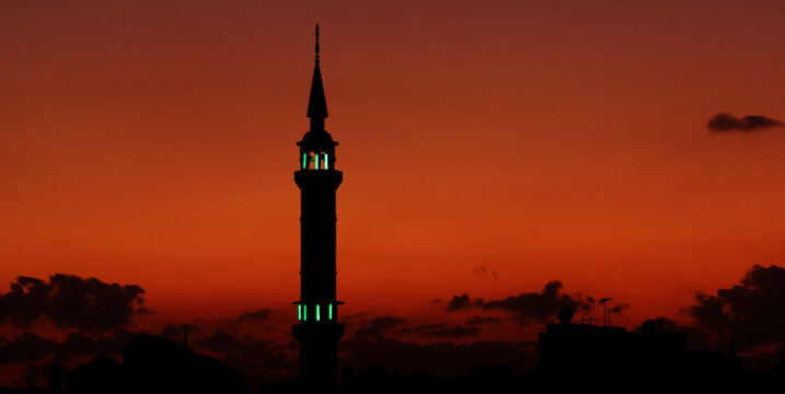 Silhouette of a Mosque near nile river at sunset Assouan Egypt. A breathtaking silhouette of a mosque against a fiery sunset sky over the Nile River is one of the most iconic images of Aswan Egypt