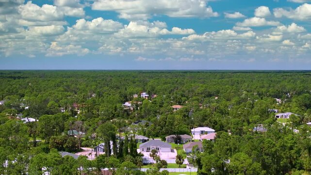 Overhead view of small town neighborhood with single family houses, driveways and trees. Calm suburban living, property ownership and American dream lifestyle concept.