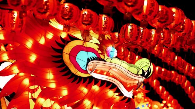 Illuminated Chinese dragon lantern display at night festival