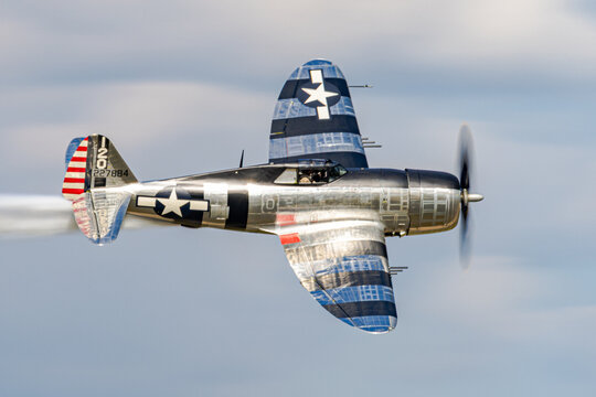 P 47 Thunderbolt banks above an air show crowd