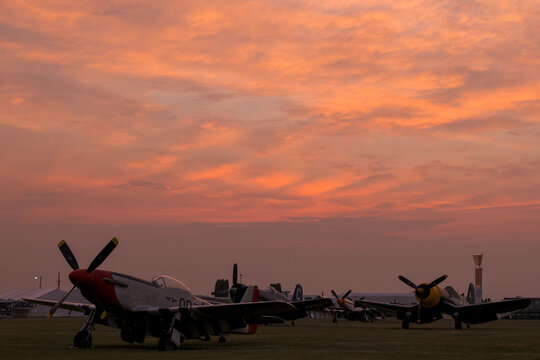 P 51 Mustang and F4U Corsair warbirds at sunset