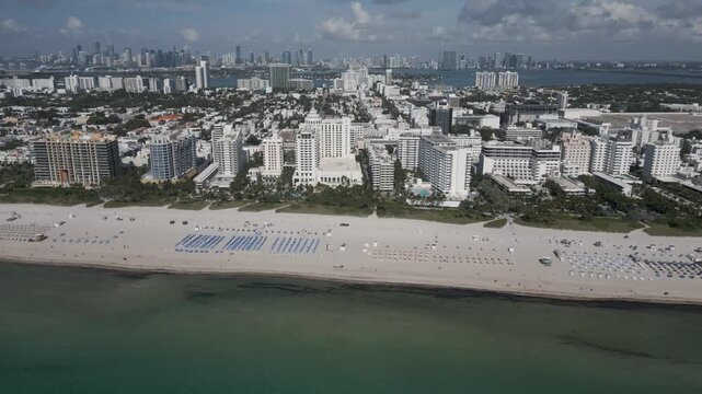 Aerial cruise along miami beach hotels facing a calm turquoise coastline