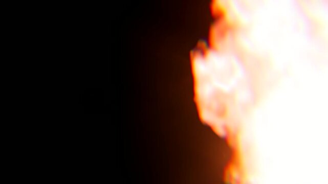 Intense fire explosion burst and glowing flame effect coming from the side frame on a dark background, suitable for action scenes, fire element overlays, and dramatic VFX.