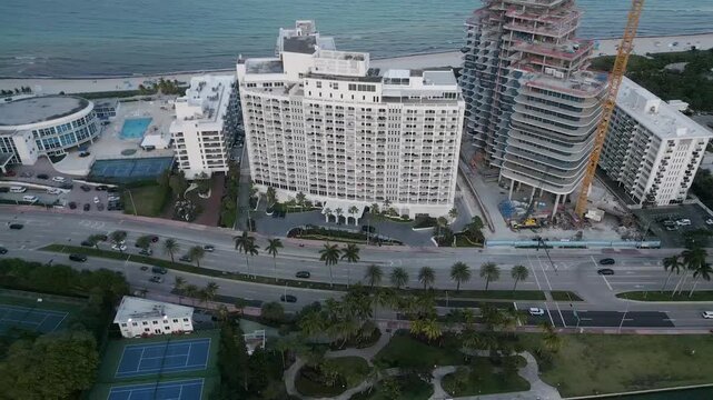 Aerial sweep past miami beach high rises and a marina lined waterway