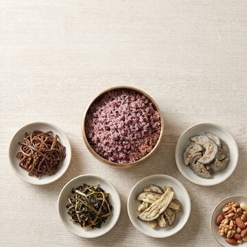 Overhead Korean multigrain rice with dried seasoned vegetable side dishes in white bowls