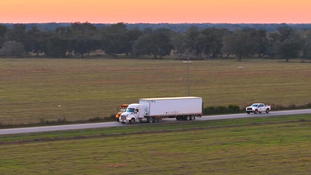 Semi truck overtaking school bus on rural highway. Dangerous driving and road rage concept.