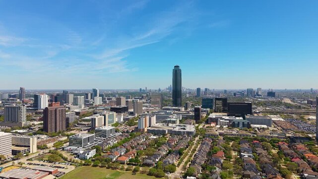 Suburban neighborhood in Uptown Houston with private houses and modern office towers. American city blends residential living with commercial growth.