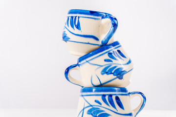 Talavera ceramic cups stacking, traditional mexican pottery craft