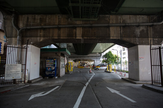 Empty road passing under a concrete railway underpass