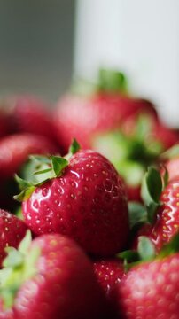 Freshly Picked Ripe Strawberries Fill A Crate, Offering A Close-Up View, Vertical Video